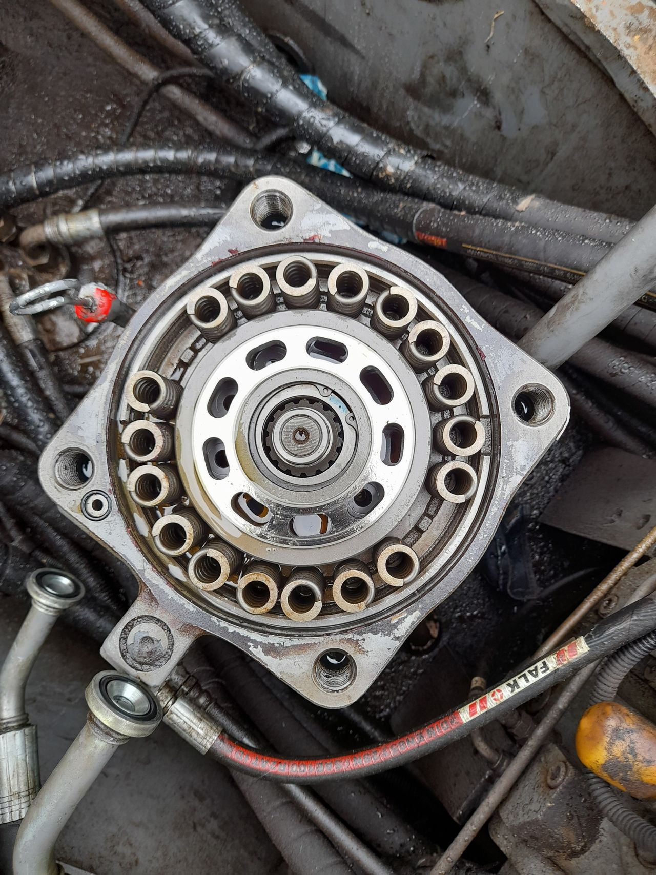 Close-up of hydraulic cylinder and fittings on heavy equipment